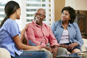 Nurse Making Notes During Home Visit With Senior Couple. Photo by Thinkstock.